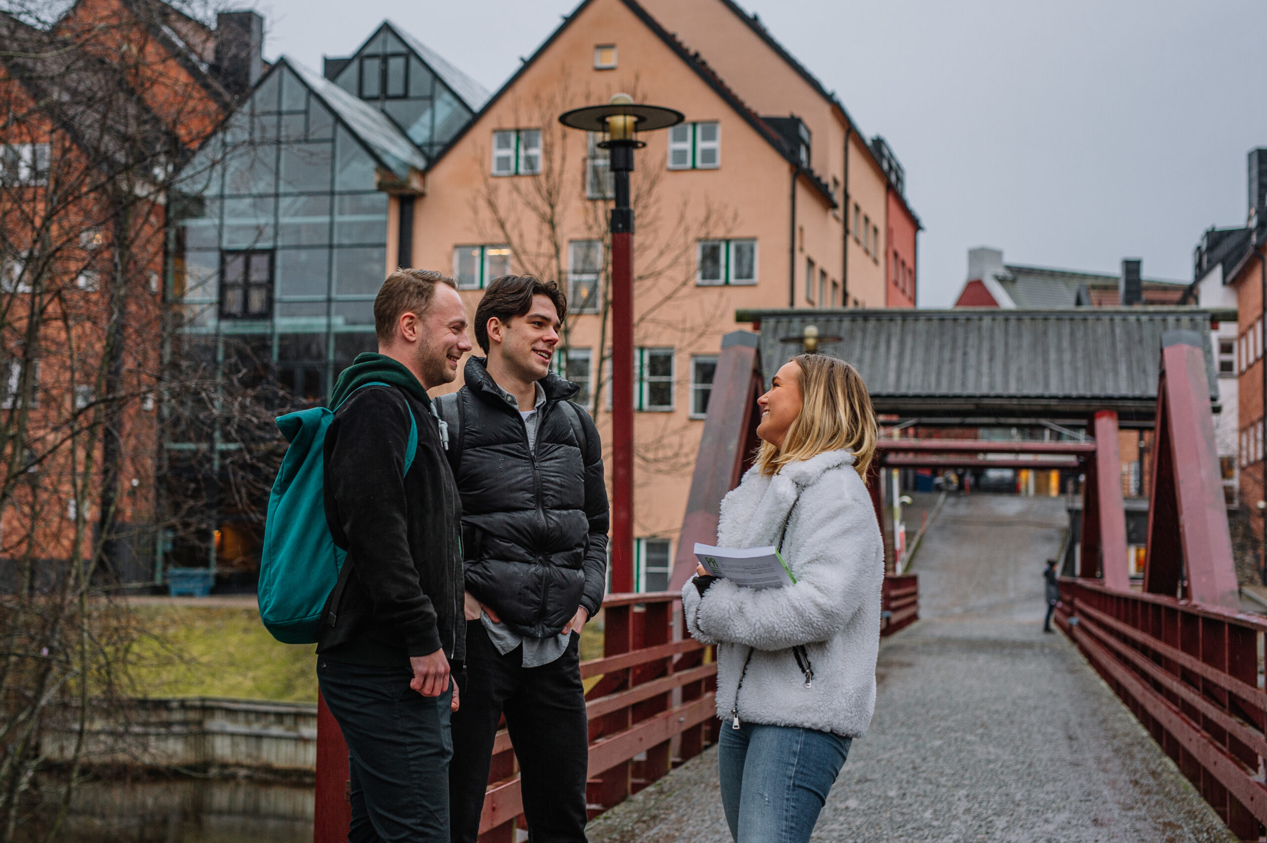 Three young people talking outside.