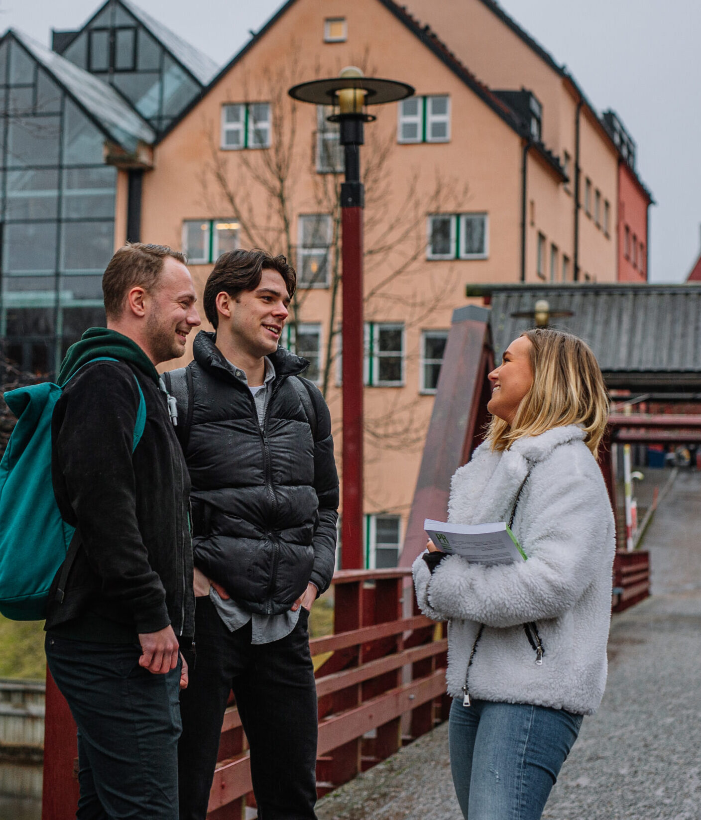 Three young people talking outside.